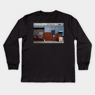 View of brick wall with spray paint in urban street in New York City Kids Long Sleeve T-Shirt